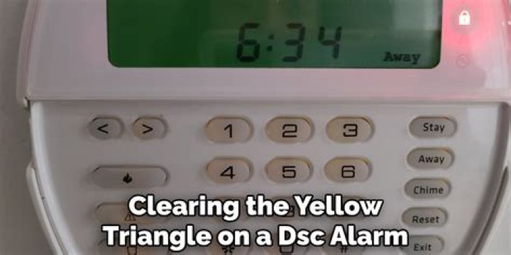 What does the yellow trouble light on my DSC keypad mean?